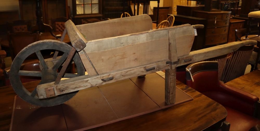 A vintage wooden garden wheelbarrow, L.176cm